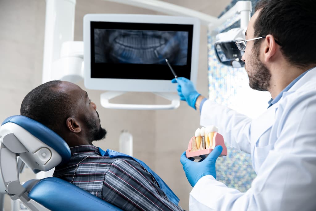 A dentist monitoring implant health.
