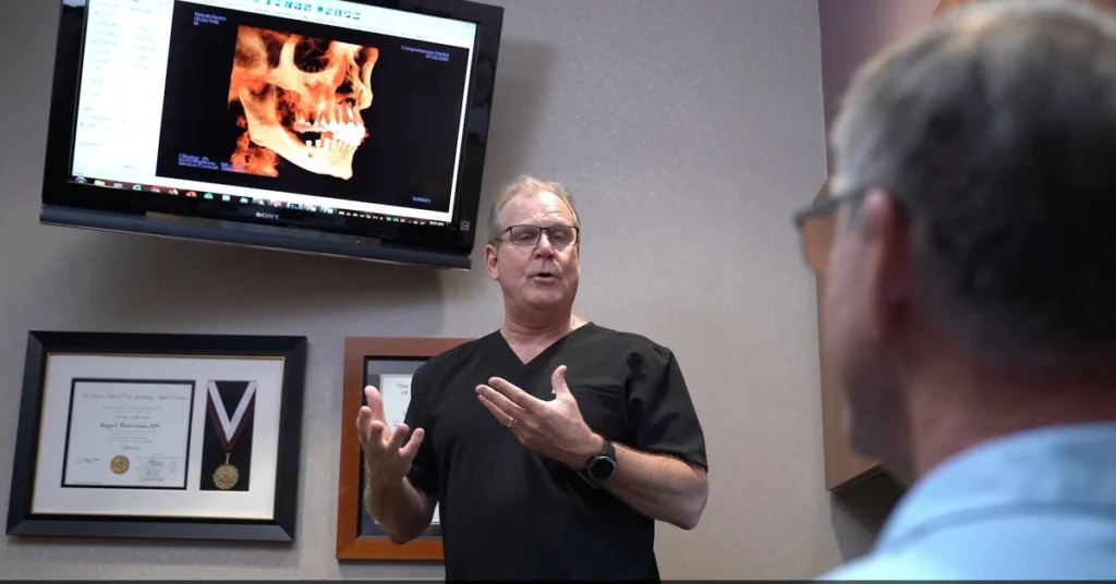 Consultation about implant-supported bridge options at Comprehensive Dental Implant Center.